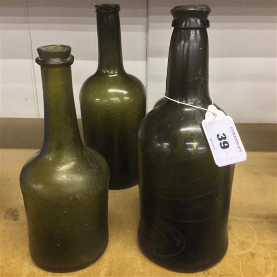 Four Dutch olive green glass bottles, late 18th century, 21.5 - 24.5cm(-)